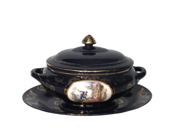 FRAZARTE (Portugal), Sopeira com presentoir confeccionada em porcelana portuguesa esmaltada na tonalidade azul cobalto, decorado por elementos florais e realces em ouro, centro com pintura de cena galante em policromia, apresentando falhas na douração, marcado no verso, sopeira medindo 20x34x20cm e presentoir 39,5x28cm. — FRAZARTE